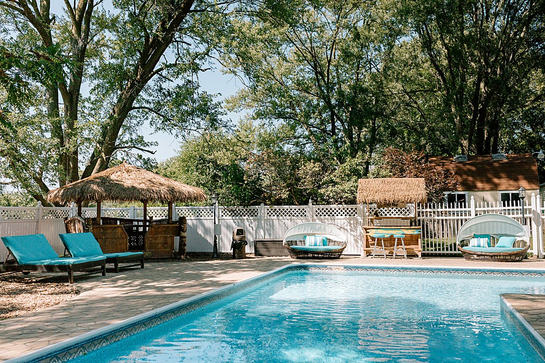 Urban Oasis resort-style pool with tiki huts and loungers